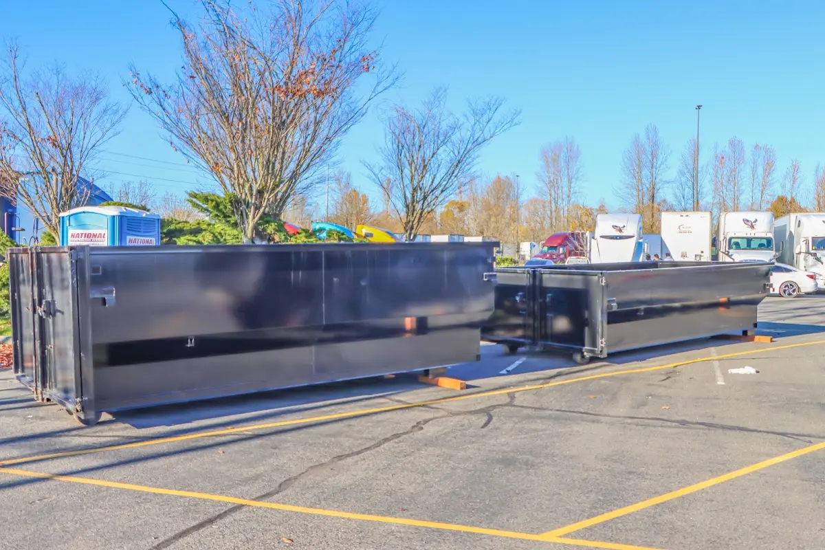 Professional dumpster rental service with roll-off container on residential driveway in Obetz